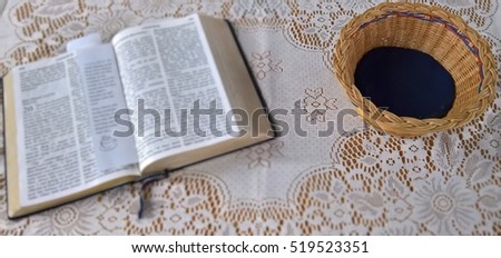 Bible and offering collection bowl, christian background 