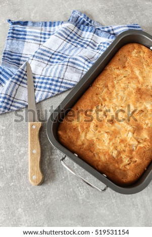 Fish pie on the gray table and white brick wall background