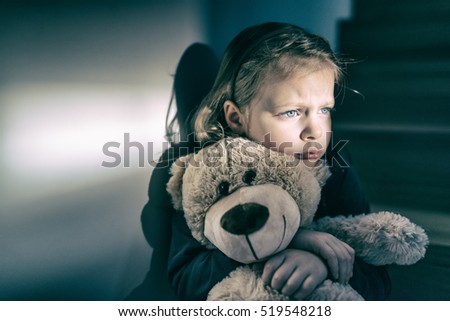 Little girl embracing her teddy bear - feels lonely -  if you are small sad girl teddy bear is willing to be your best friend - instagram filter applied Royalty-Free Stock Photo #519548218