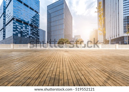 Empty wood floor with modern business office building