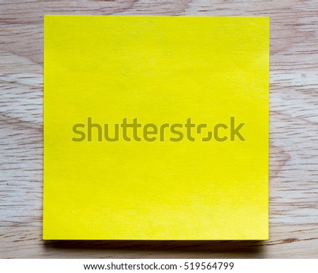 stick note isolated on wood background.close up of a vintage note paper.Vintage yellow .image for background,wallpaper and copy space.
note paper.
