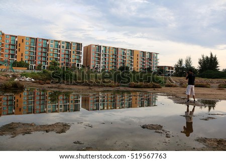 Twin towers with photographer reflected in the water with a beautiful plant mangroves along the coast of Thailand. 