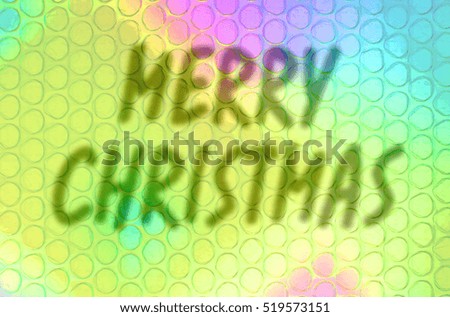 The inscription on a colored background. Merry Christmas. Blurred