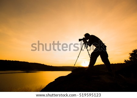 photographer silhouette with sunset or sunrise