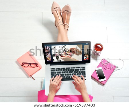 Woman watching online tutorial on laptop. Makeup and beauty blog. Royalty-Free Stock Photo #519597403