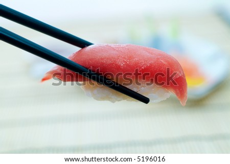 Sushi with chopsticks, With a back background