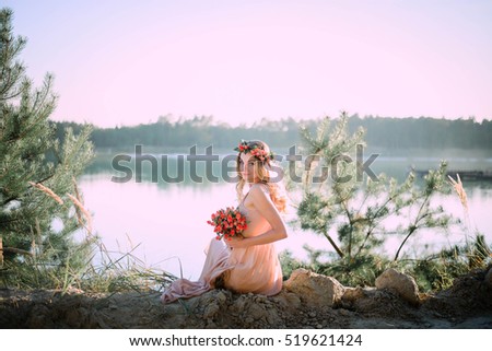 charming and young woman sitting alone on the shore
