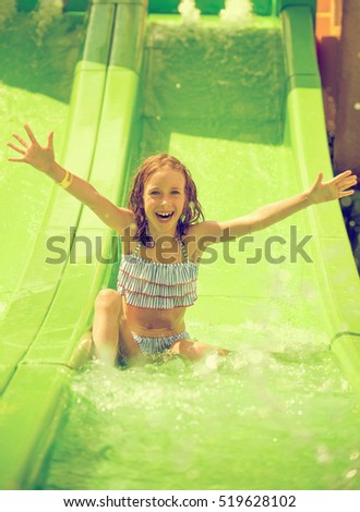 Little girl having fun in aquapark.