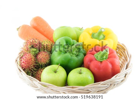 group of Fresh vegetables three sweet Red, Yellow, Green Peppers green apple, rambutan ,carrot  in  basket on white background