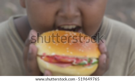 The boys eat hamburgers.picture blur.