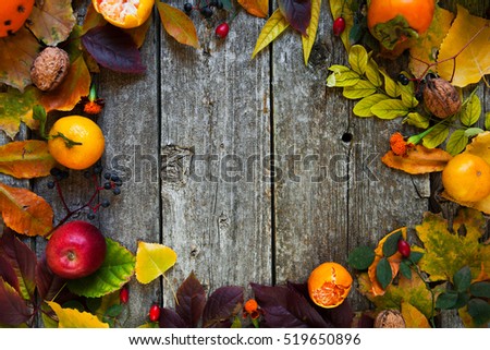Autumn background with colored leaves on wooden rustic background with copy space