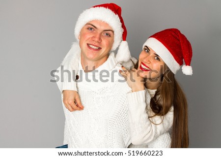 couple in love celebrates christmas in santa hat