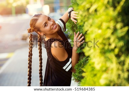 Cute girl teenager with two pigtails hair braids posing for camera