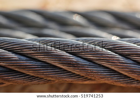 Industrial twisted metal tow cable for heavy vehicles or machinery Royalty-Free Stock Photo #519741253