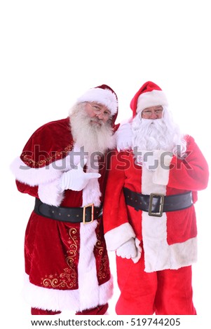Two Santa Claus friends pose together. isolated on white with room for your text