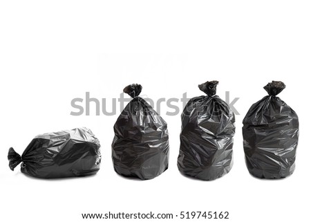 Four black bags of rubbish on a white background Royalty-Free Stock Photo #519745162