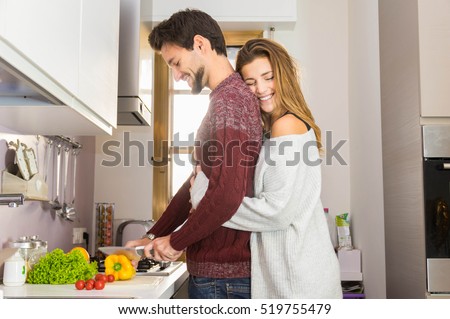Loving couple cooking together in the kitchen at home Royalty-Free Stock Photo #519755479