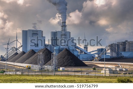 Heavy industrial coal powered electricity plant with pipes and smoke in black and white Royalty-Free Stock Photo #519756799