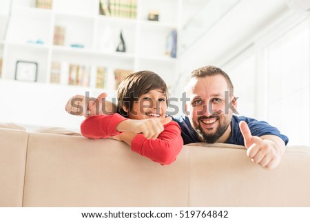 Happy father and son at modern new white home