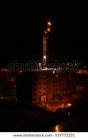 blurred image. construction of the building. Crane at night. background