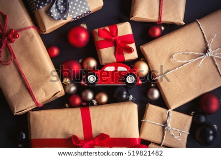 Christmas gift and little toy car for delivery on grey background