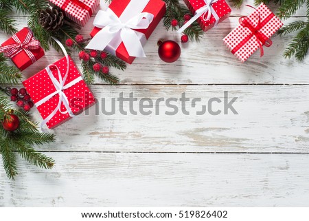 Christmas gift box.  Christmas presents in red boxes at white wooden table. Flat lay with copy space.