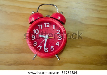 Red clock on wooden background for business idea concept deadline Key appointments 