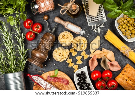Italian food ingredients with pasta and herbs Royalty-Free Stock Photo #519855337