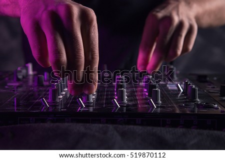 DJ sound equipment at nightclubs and music festivals, EDM, future house music and so on. Parties concept, sound technique. DJ playing on the best, famous CD players. Royalty-Free Stock Photo #519870112