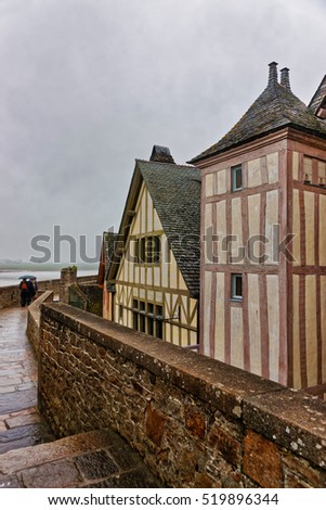 Old Houses in Mont Saint Michel in Normandy region at Manche department of France. People on the background