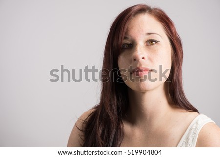 Pretty young woman against a white backdrop.