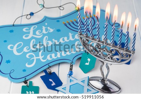 Image of jewish Hanukkah holiday with menorah burning candles.