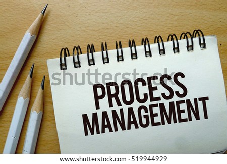 Process Management text written on a notebook with pencils
