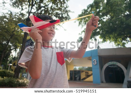 Little boy playing and test how to fly with  plastic airplane science education 