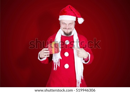Funny man dressed as santa claus with gift