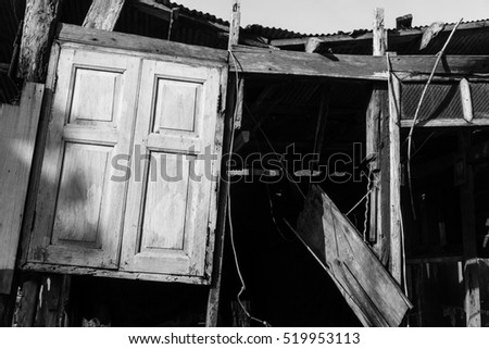 Black and white picture. Wooden building and Old window