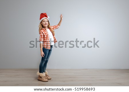 Little smiling girl holding the bell