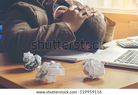 businessman failing and serious in office. Royalty-Free Stock Photo #519959116