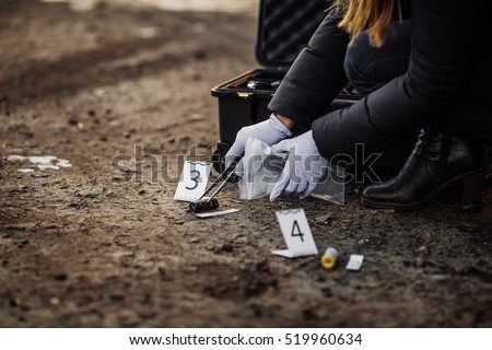 Crime scene investigation - collecting evidence Royalty-Free Stock Photo #519960634
