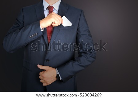  business man taking out business card from the pocket of business  modern suit