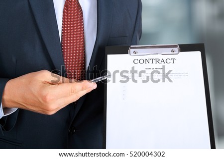 Business man is offering to sign  a contract, business contract details