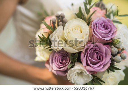 closeup photo of bride holding a flower bouquet. wedding decoration background