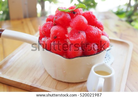 fresh red watermelon in a bowl on wooden table