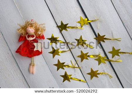 Christmas angel. christmas decoration handmade toy Angel with stars on a wooden background