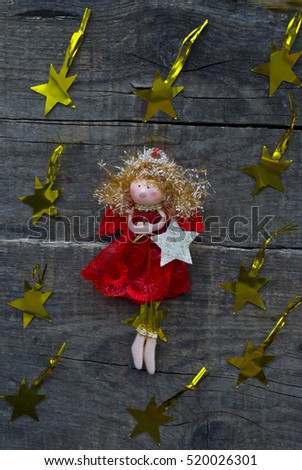 Christmas angel. christmas decoration handmade toy Angel with stars on a wooden background