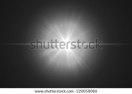 Abstract lens flare light over black background Royalty-Free Stock Photo #520058086