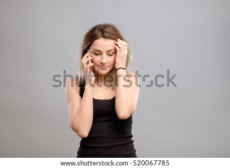 Woman mobile phone talking. Teenager girl isolated portrait on gray background