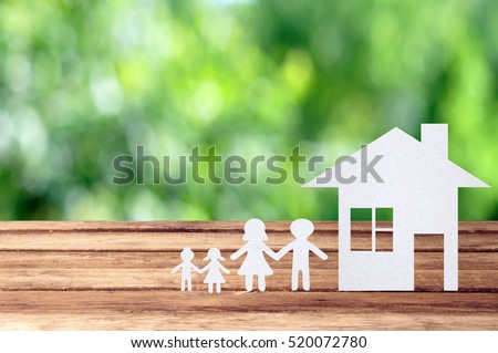 Paper family on wooden table with garden bokeh outdoor theme background