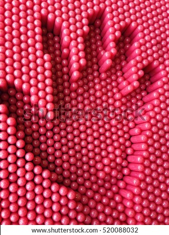 Hand print on the red pins toy background, playground equipment board 