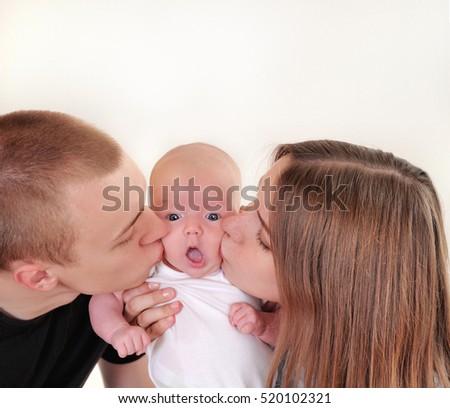 family portrait of little cute baby and parents kissing her, happy family concept